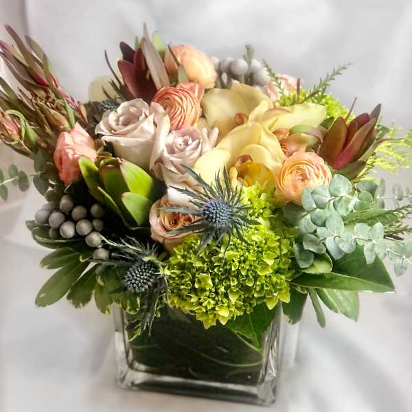 Mixed pastel bouquet in a square glass vase