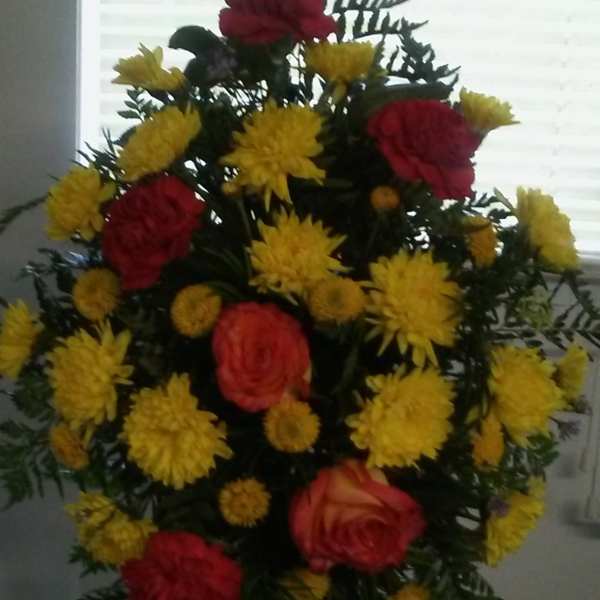 Standing floral spray with red roses and yellow chrysanthemums