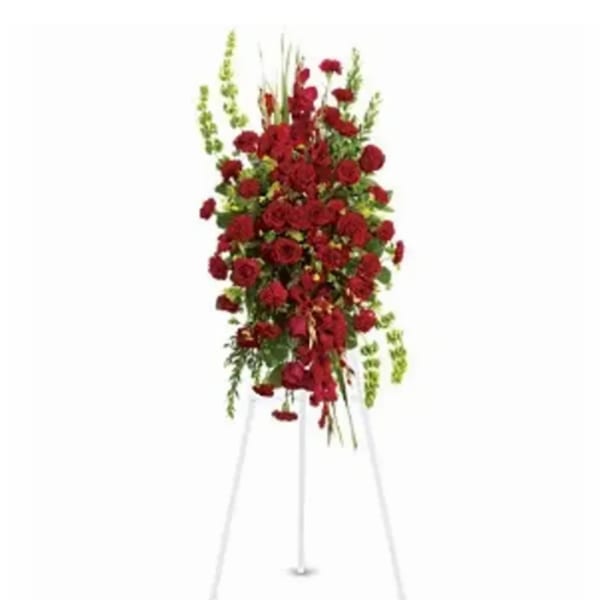 Tall standing spray of red flowers on a white easel