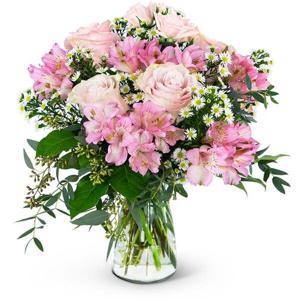 Pink roses and alstroemeria in a clear glass vase