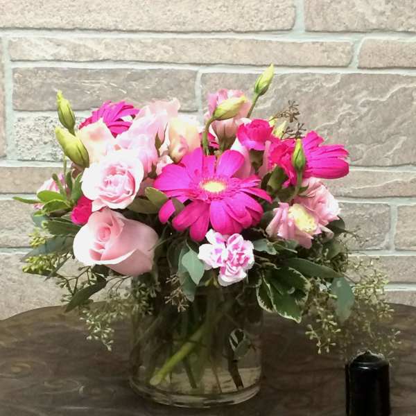 Pink and white mixed bouquet in a clear glass vase
