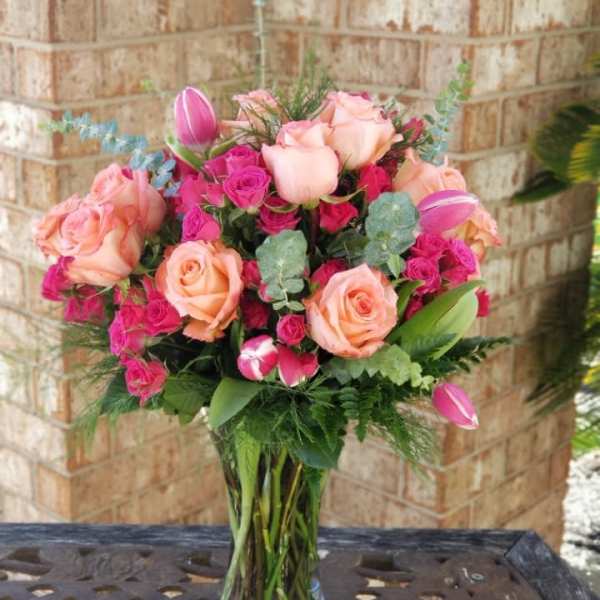 Pink and peach rose bouquet in a clear glass vase