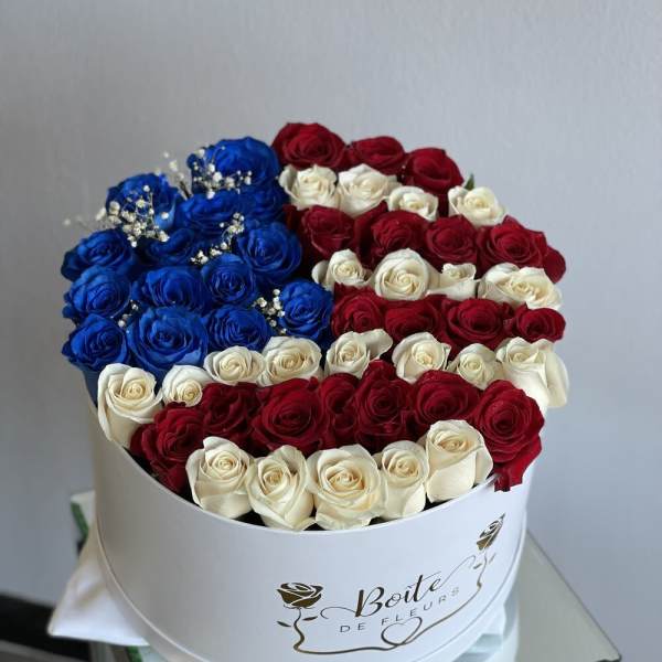 Round box of red, white, and blue roses with baby's breath