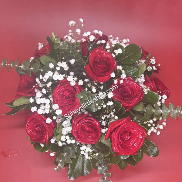 Bouquet of red roses with white baby's breath on a red background
