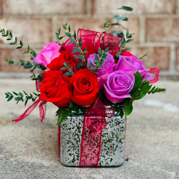 Bouquet of red and purple roses in a square decorative box