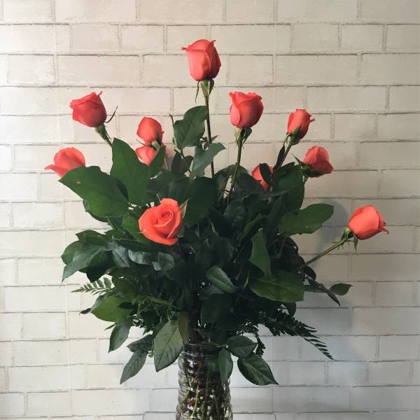 Coral rose bouquet in a clear glass vase