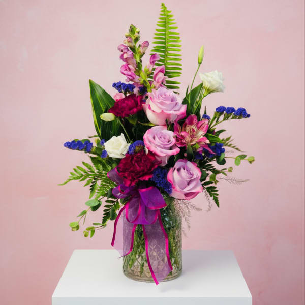 Bouquet of pink and white roses in a glass vase