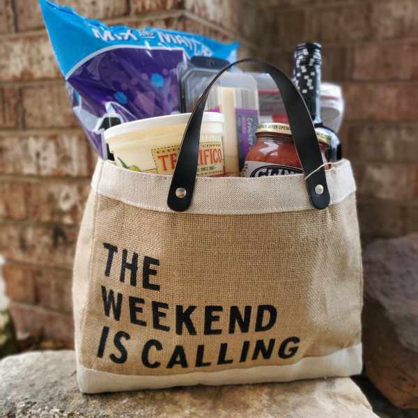 Gift tote filled with snacks and a bottle of wine