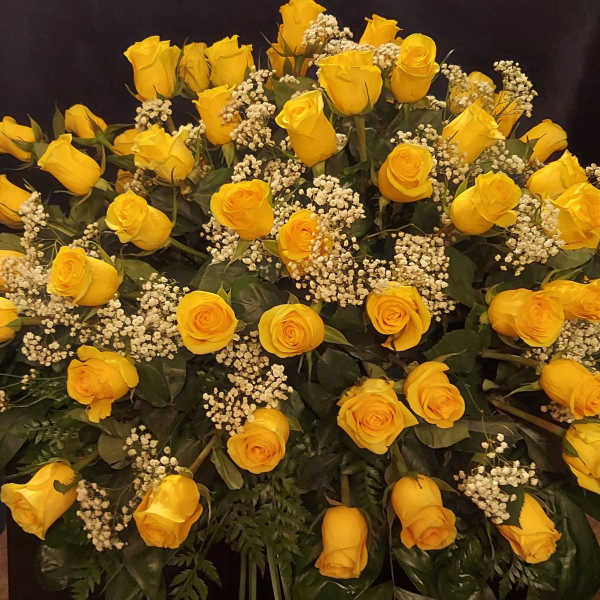 Large bouquet of yellow roses with white filler flowers