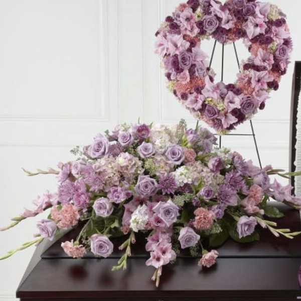 Lavender floral heart wreath on an easel above a matching flower spray