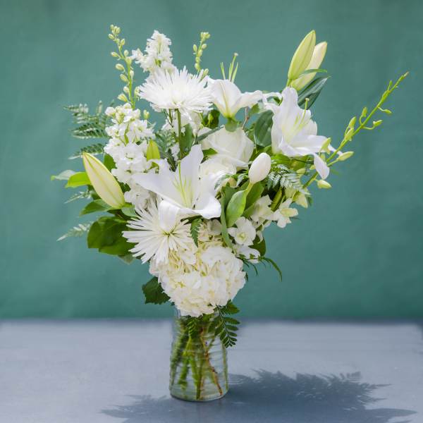 White floral bouquet in a clear glass vase