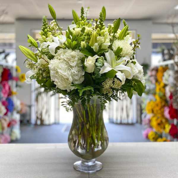 White floral arrangement in a clear glass vase