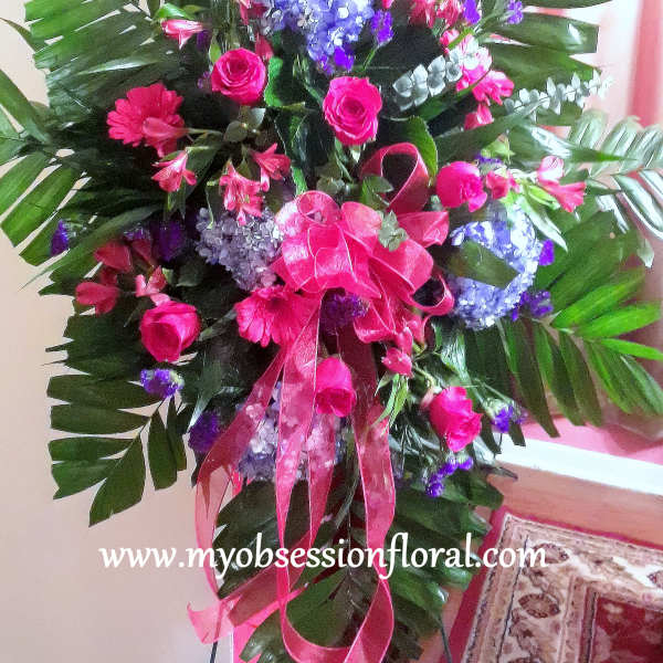 Large pink and blue floral standing arrangement with ribbon