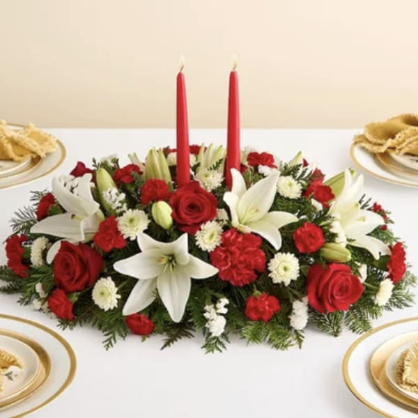 Red and white floral centerpiece with two red candles
