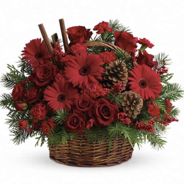 Red roses and gerbera daisies in a wicker basket with pinecones