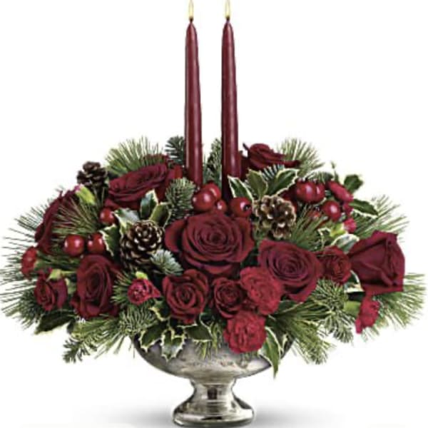 Red rose centerpiece with two tall burgundy candles in a silver bowl
