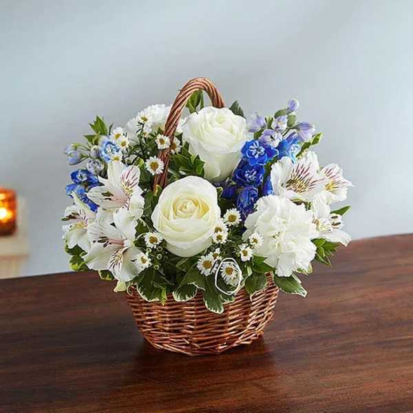 White and blue flower basket in a wicker basket