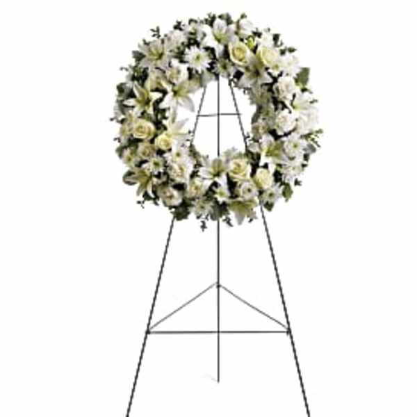 White floral funeral wreath on a standing easel