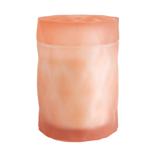 Peach-colored cylindrical candle in a frosted container