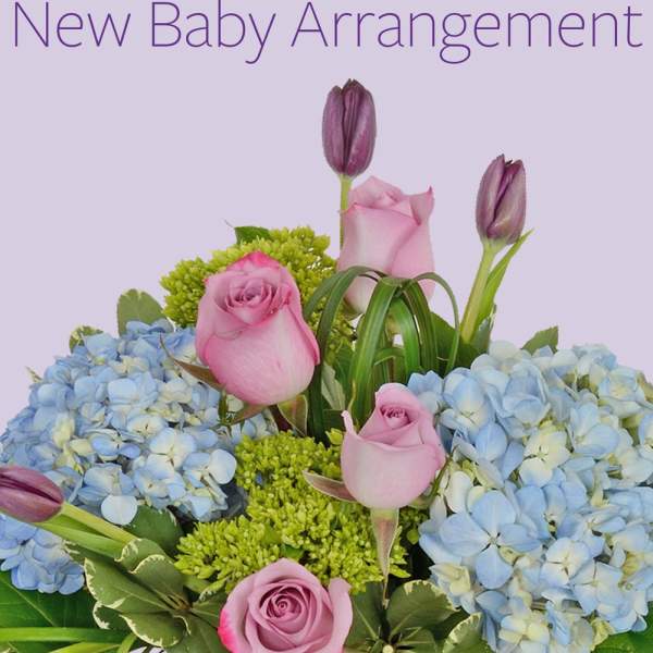 Pink roses and blue hydrangeas with purple tulips in a baby-themed arrangement