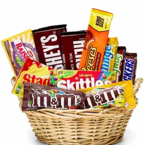 Basket filled with assorted candy bars and candy packs