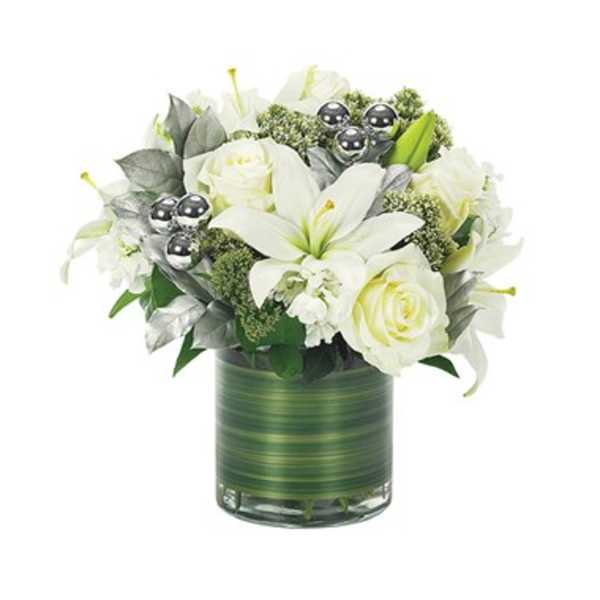 White lilies and roses in a green glass vase with silver accents