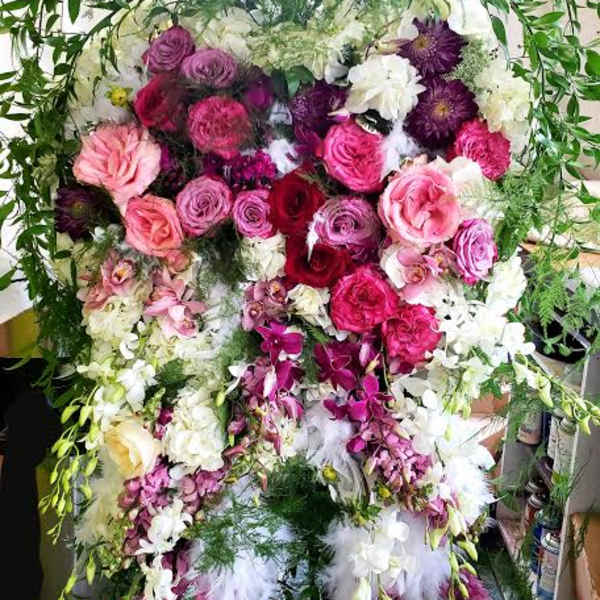 Large standing floral spray with pink, purple, and white flowers