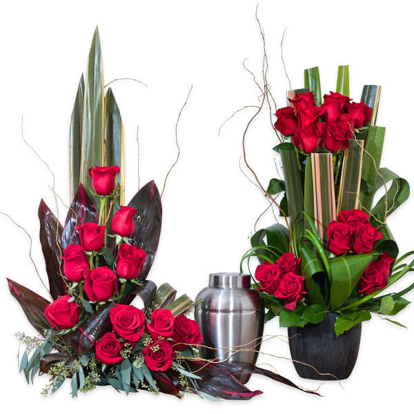 Two red rose arrangements with a silver urn between them