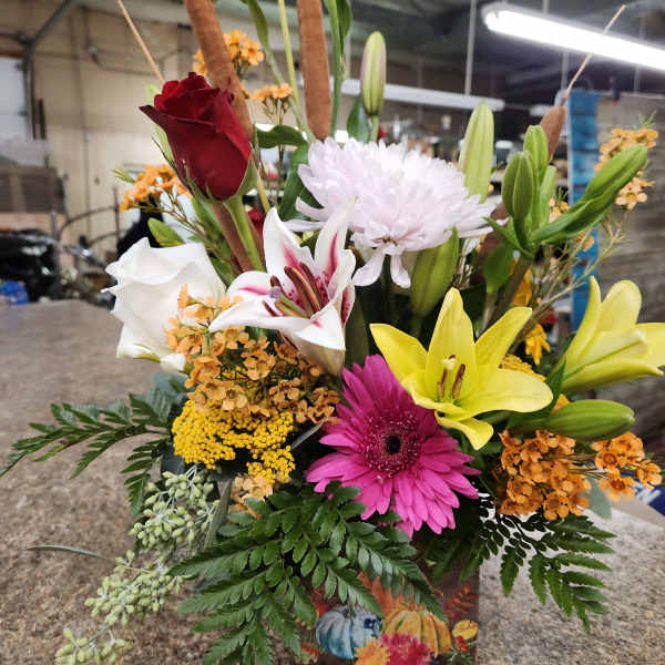 Mixed bouquet with lilies, roses, gerbera daisies, and chrysanthemums in a decorative box