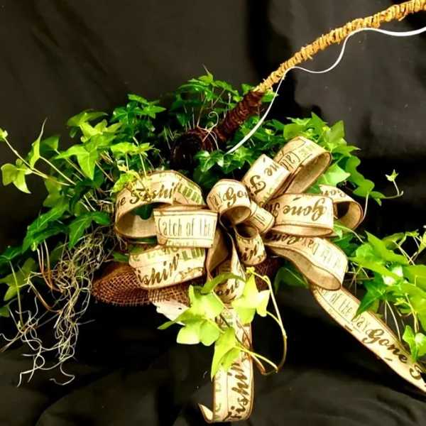 Green ivy wreath with a large decorative ribbon bow