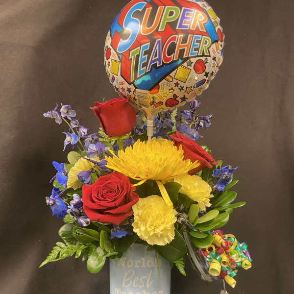 Bouquet of red roses and yellow flowers in a blue tumbler with a teacher balloon