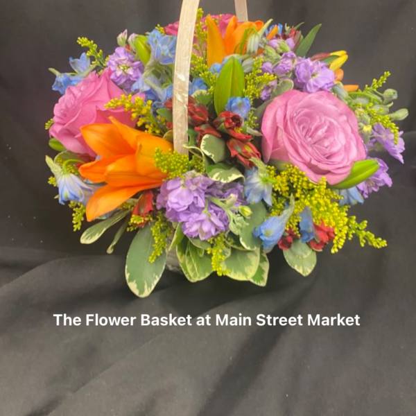 Colorful flower basket with pink roses and orange lilies