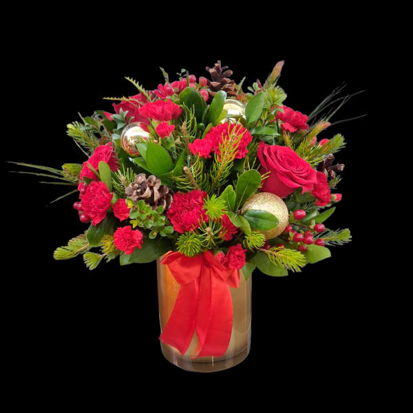 Red floral arrangement in a glass vase with a red ribbon