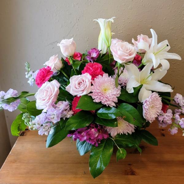 Bouquet of pink roses, lilies, and chrysanthemums with lavender accents