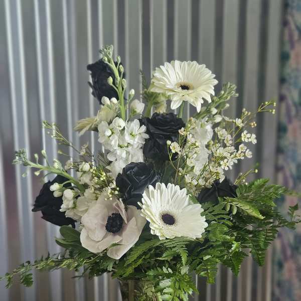 Black and white flower bouquet in a clear glass vase