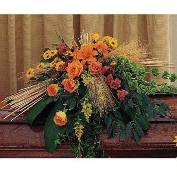 Orange and yellow floral arrangement with roses and lilies