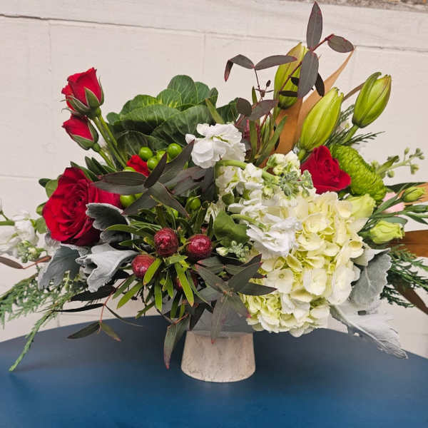 Red roses and white hydrangeas in a white vase