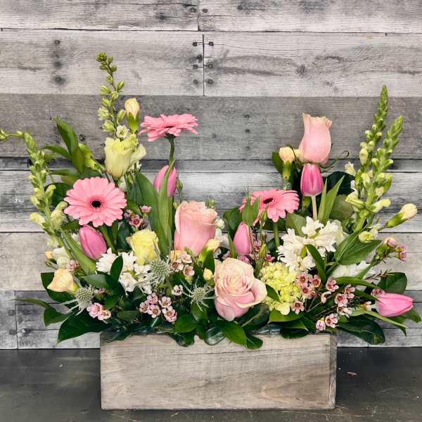 Pink and white mixed flower arrangement in a wooden box