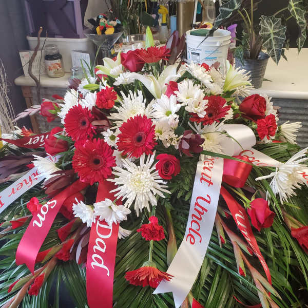 Large red and white funeral spray with ribbons
