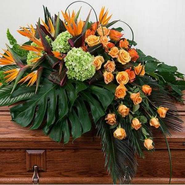 Tropical floral casket spray with orange roses and green hydrangeas