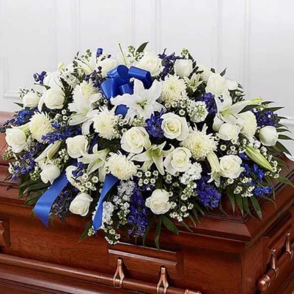 White and blue funeral spray on a casket