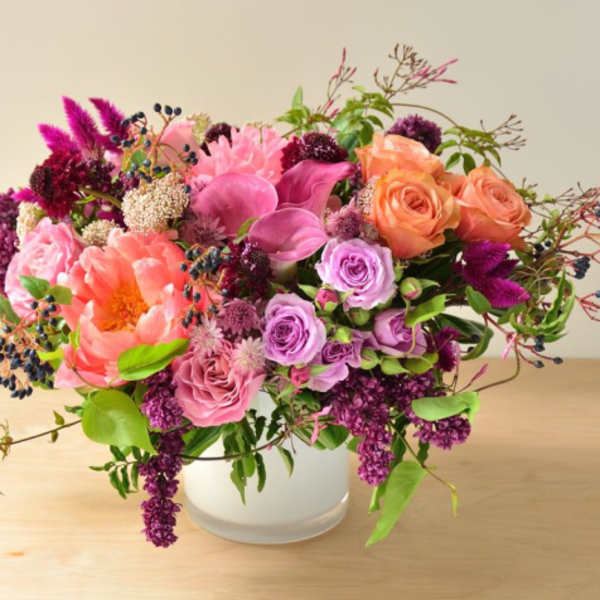 Pink and purple mixed bouquet in a white vase
