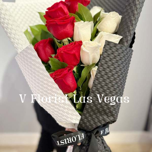 Bouquet of red and white roses wrapped in black and white paper