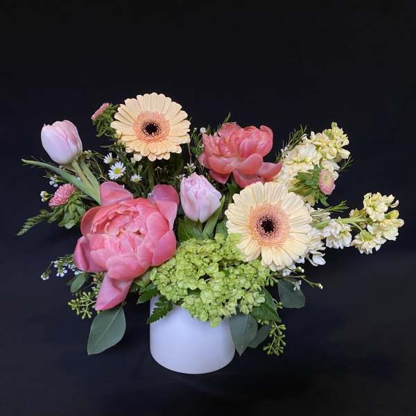 Pink and cream mixed bouquet in a white vase
