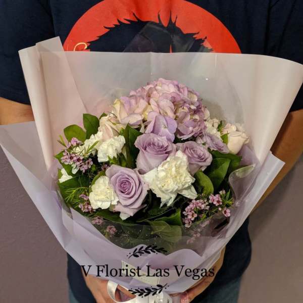 Lavender and white bouquet wrapped in translucent paper