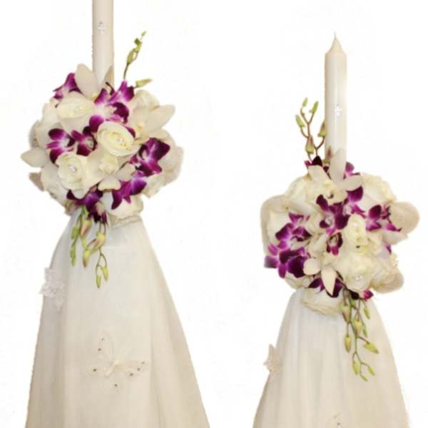 Two white floral candle arrangements with purple orchids