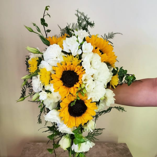 Bouquet of sunflowers and white flowers with trailing greenery