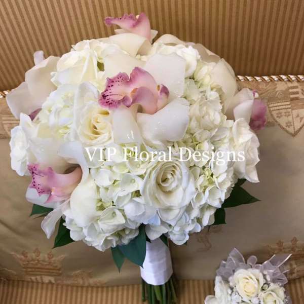 White bridal bouquet with pink orchid accents and a matching mini bouquet