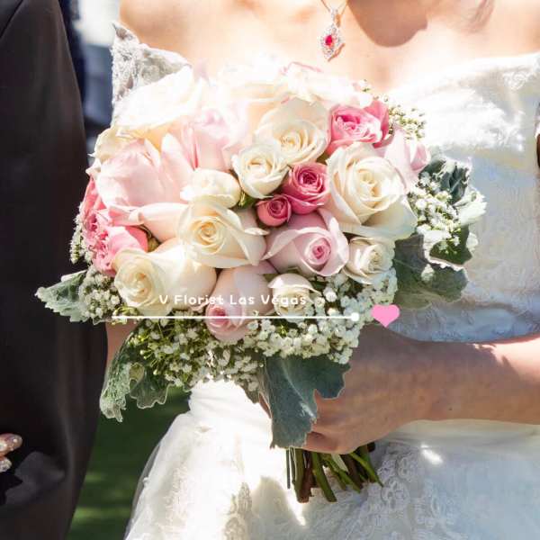 Bride holding a bouquet of pink and white roses