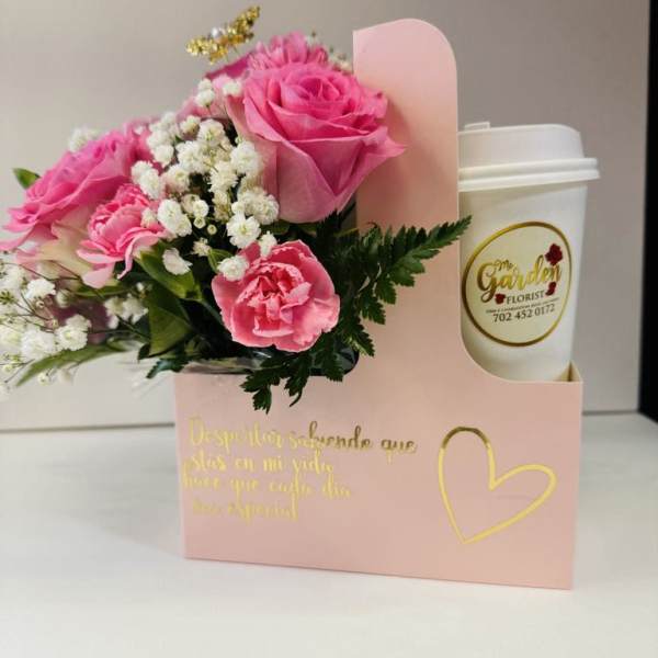 Pink roses and carnations in a gift box with a coffee cup